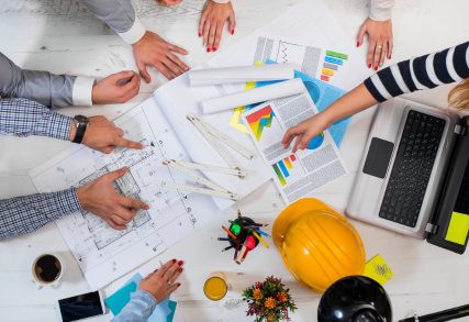 Collaborative team reviewing construction plans