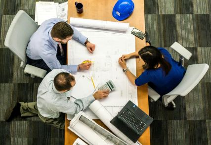 Engineers reviewing blueprints and calculations