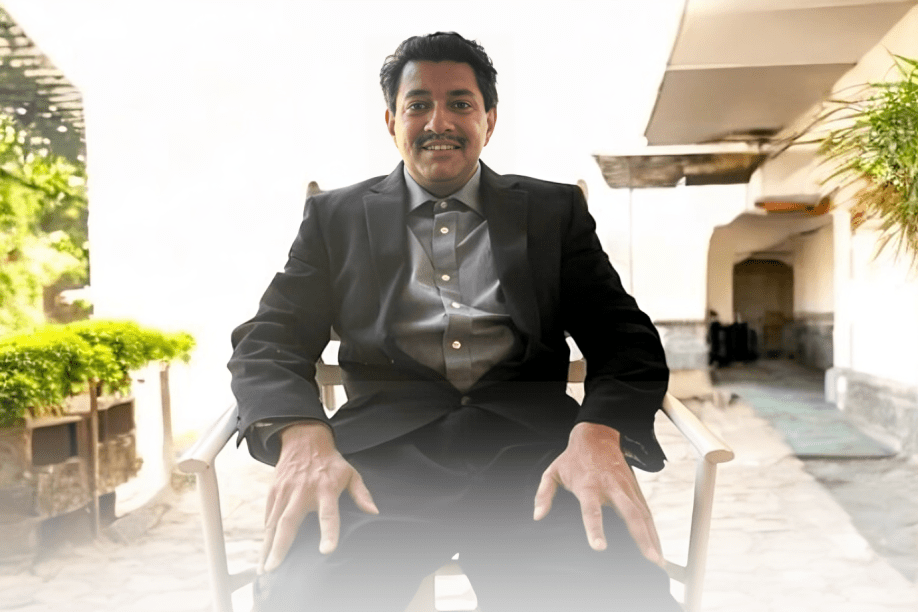 Smiling man in a chair outside